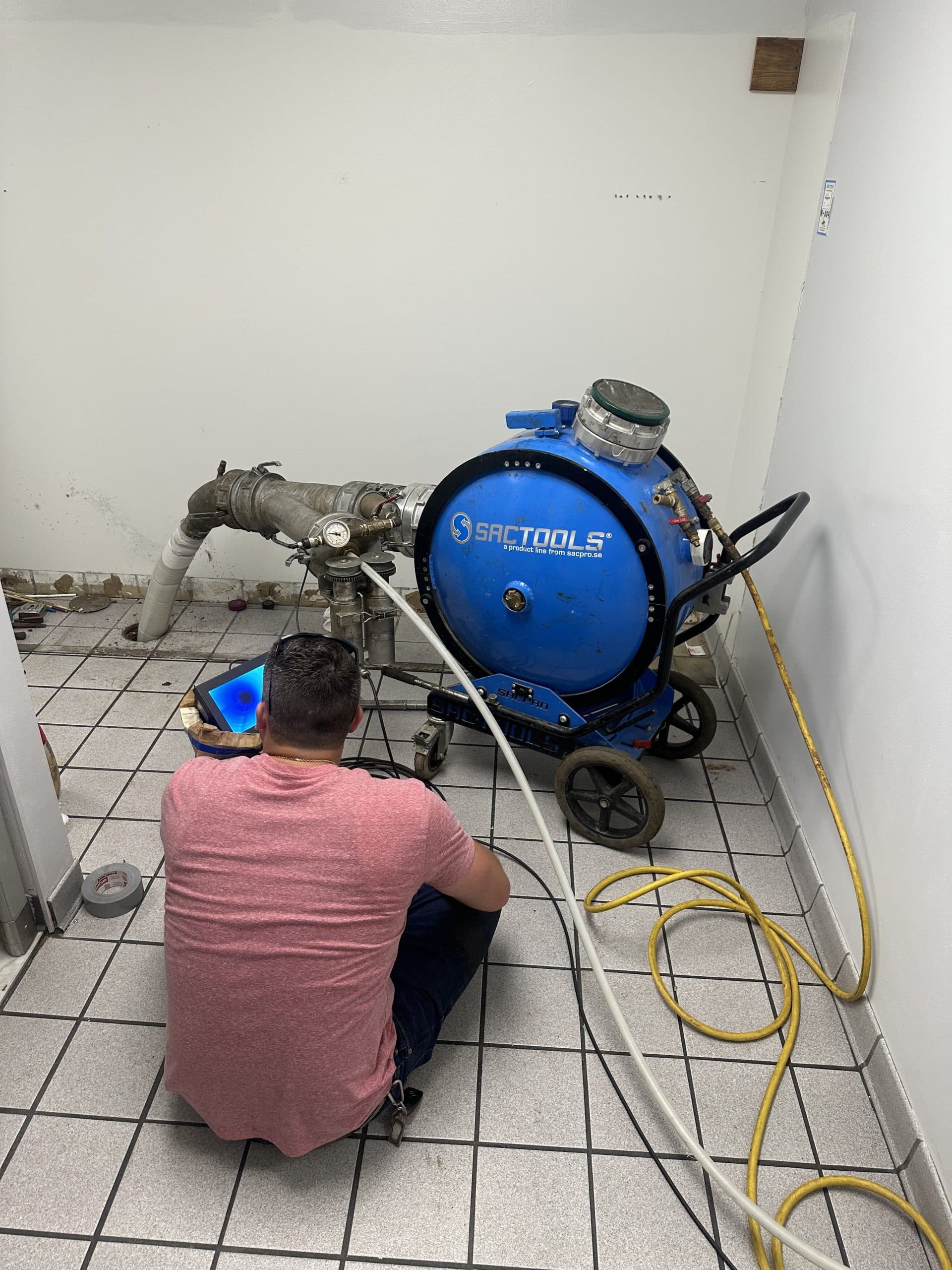 Technician monitoring an inversion drum connected through a tiled floor