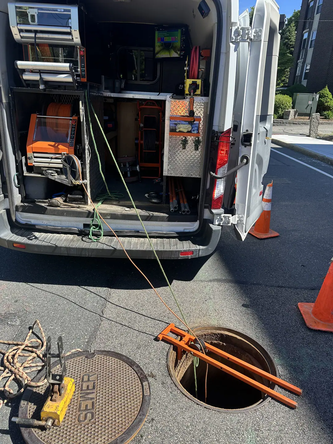 Camera equipment in a service van connected through a street access opening