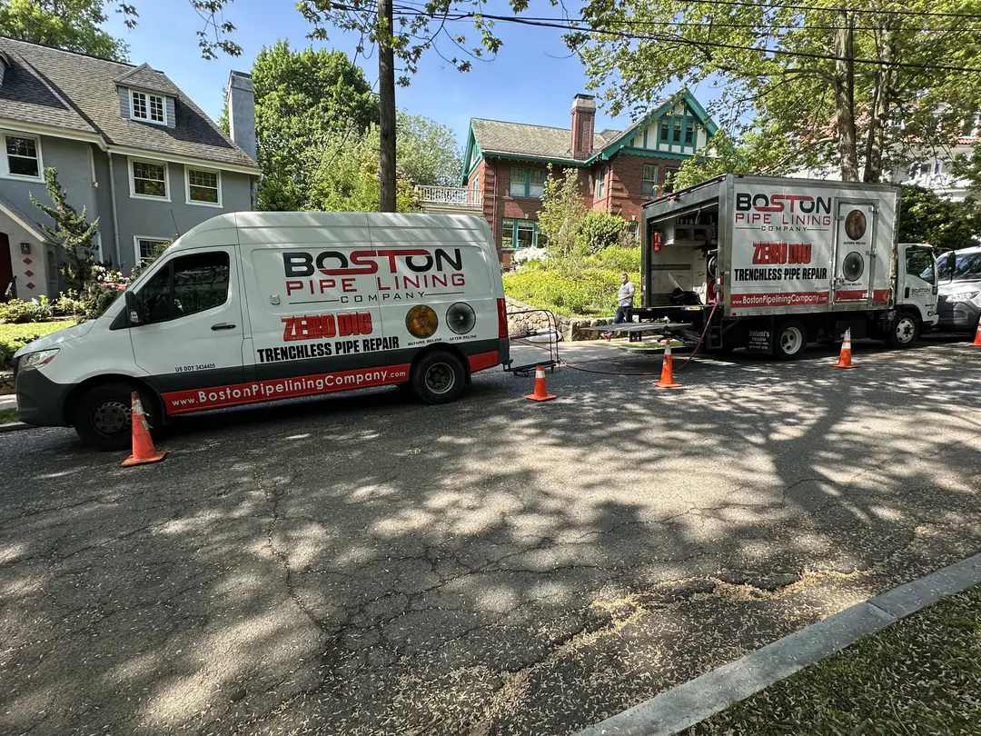 Boston Pipelining van and box truck set up outside a residential property