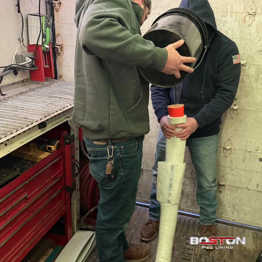 Our Boston crew preparing a resin-saturated liner at a work vehicle