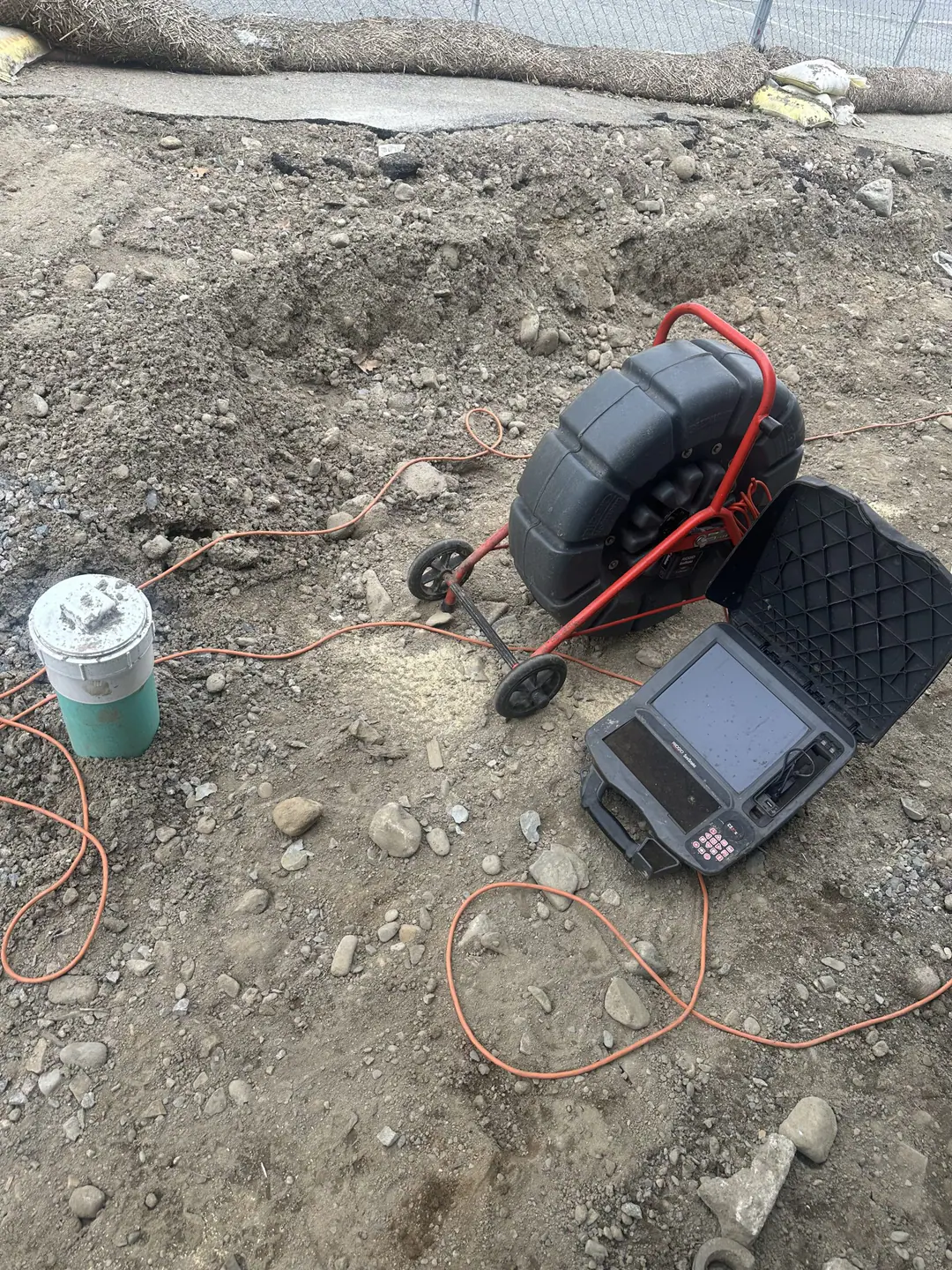 Inspection camera reel and monitor beside an outdoor sewer cleanout on our Jamaica Plain job
