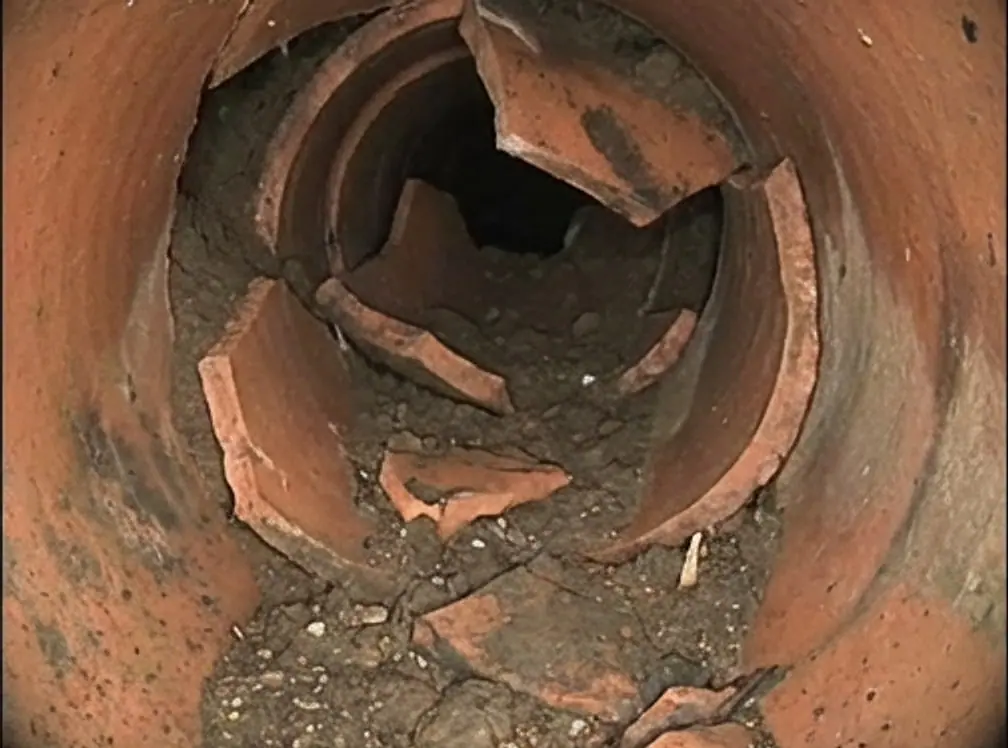 Rendering of a camera view into a sewer pipe whose wall has broken and caved in