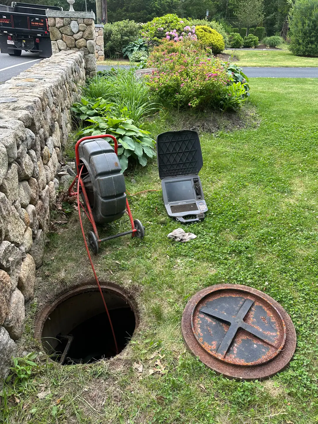 Our camera reel beside an open access in a yard on our South Boston job