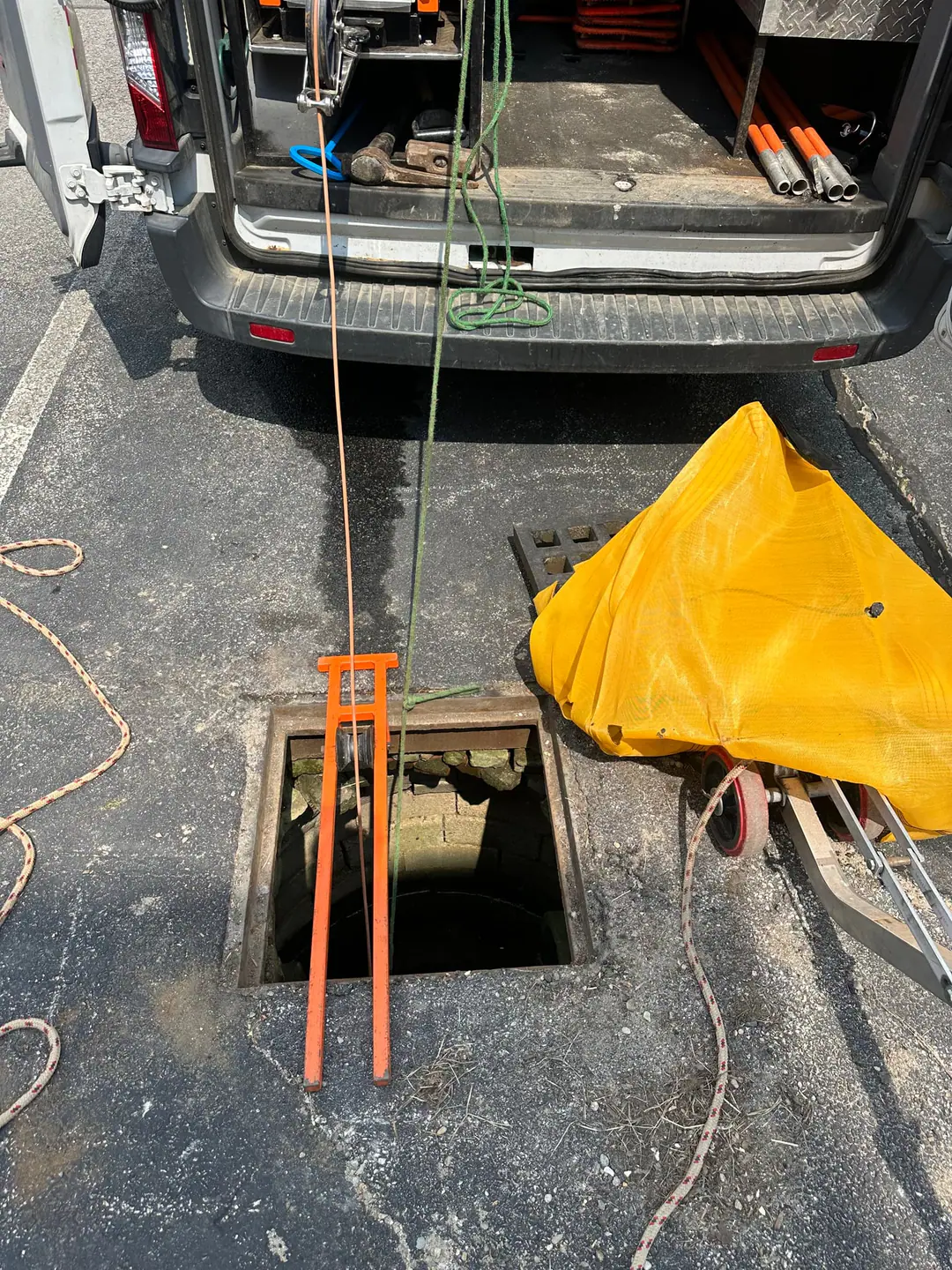 Our van with its camera line running into a street sewer access on our South Boston job