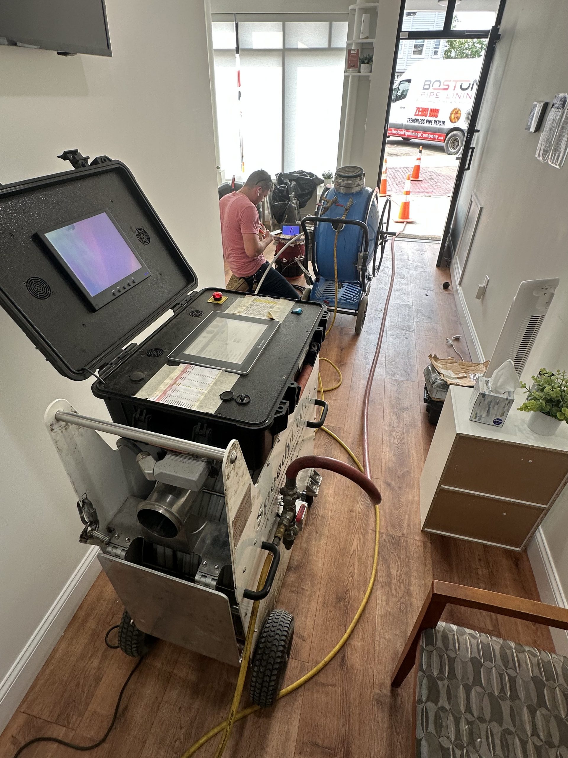 Boston Pipelining Company performing UV cured trenchless repair indoors