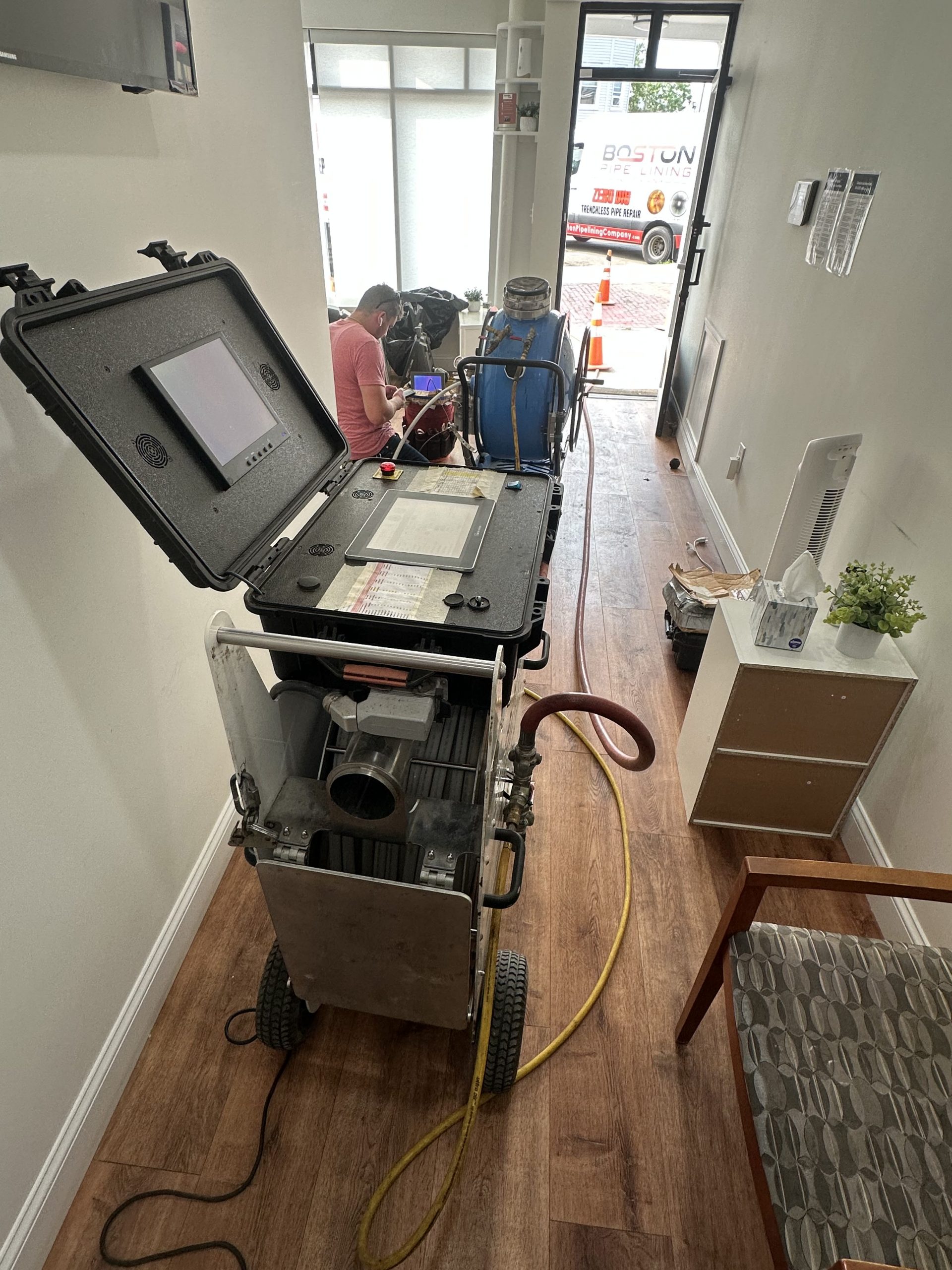 Final curing stage of trenchless sewer lining project inside Boston home