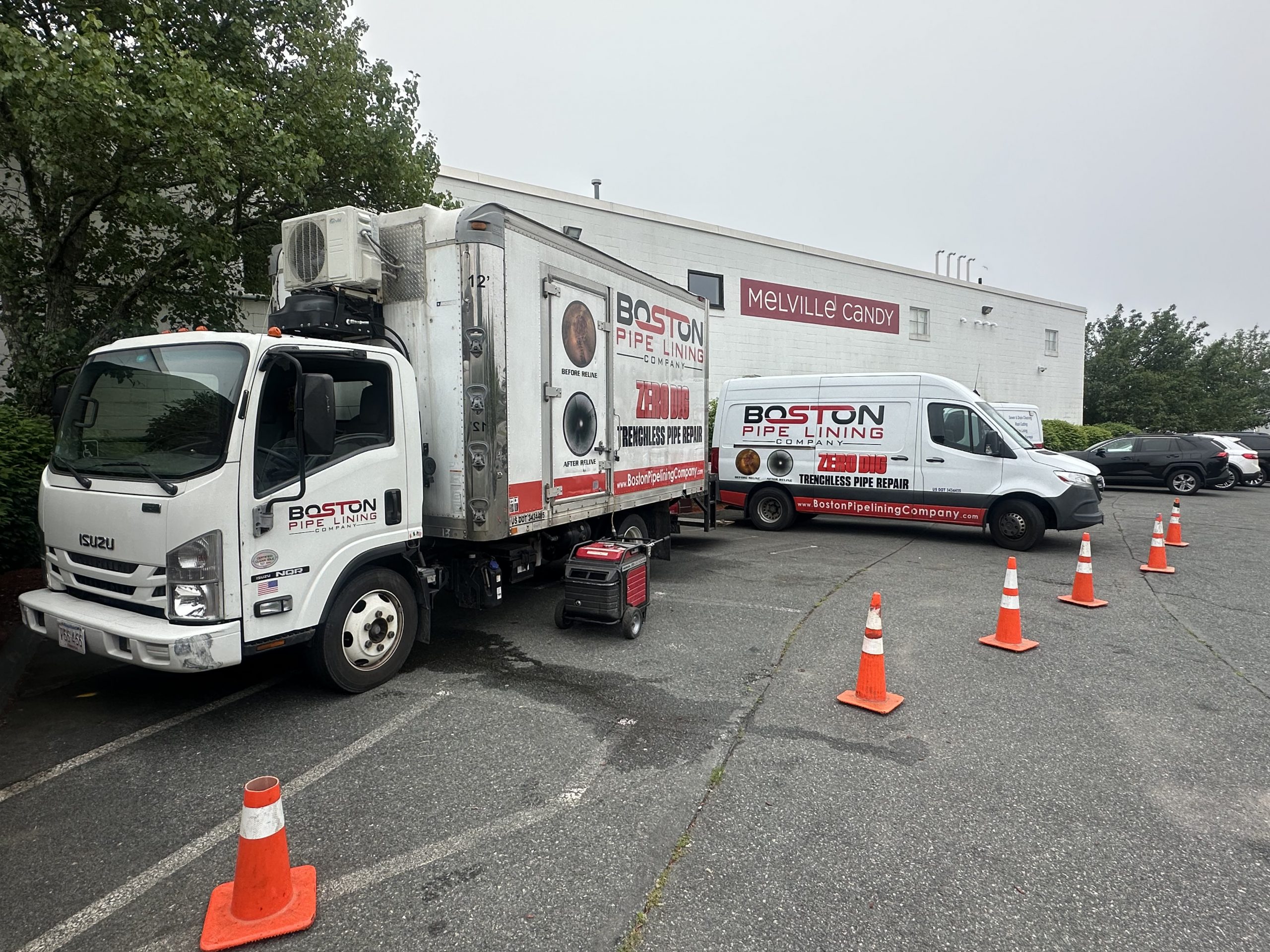 Boston Pipelining crew setting up trenchless repair equipment inside basement