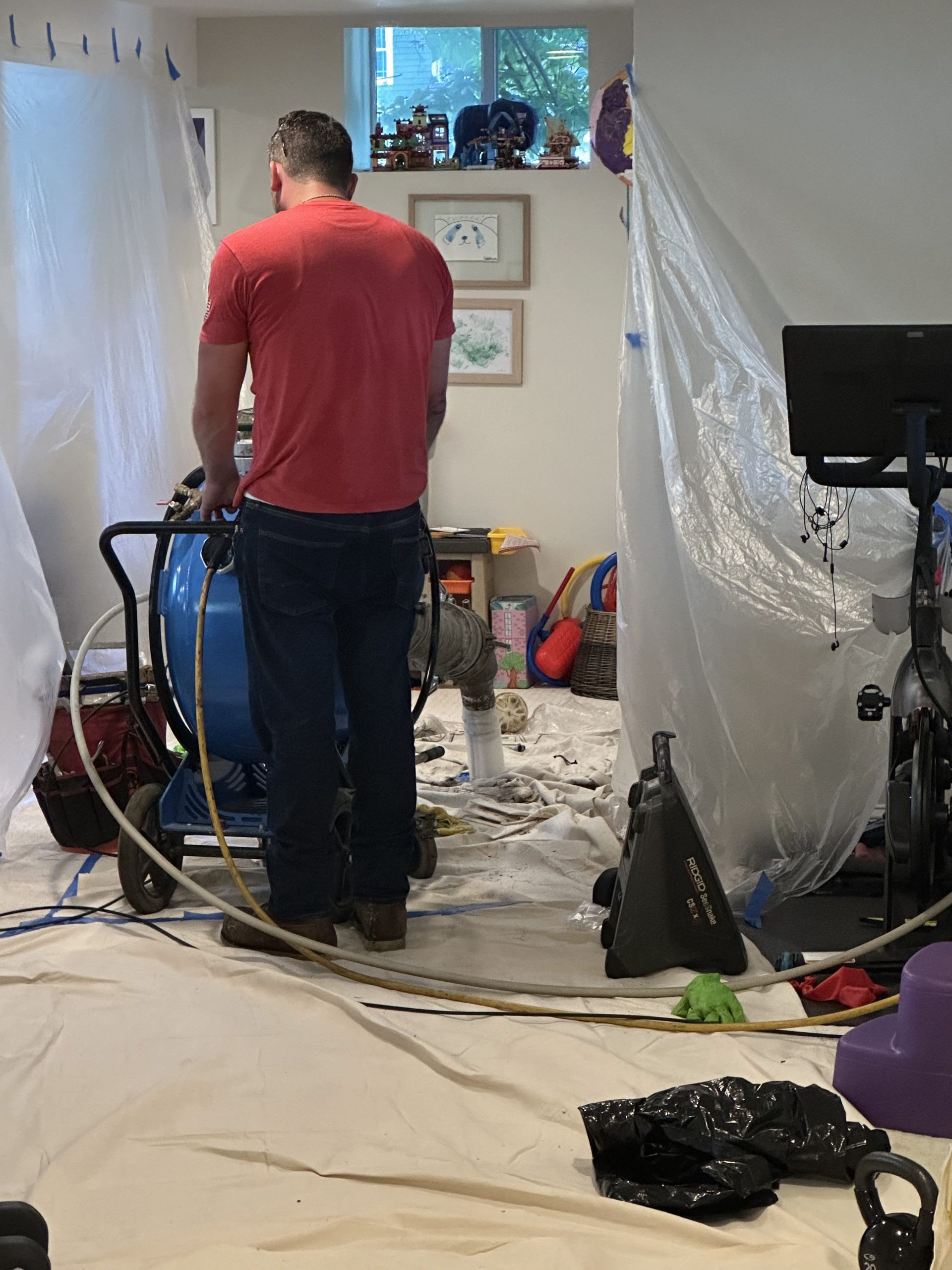 Technician inspecting sewer pipe before trenchless lining process